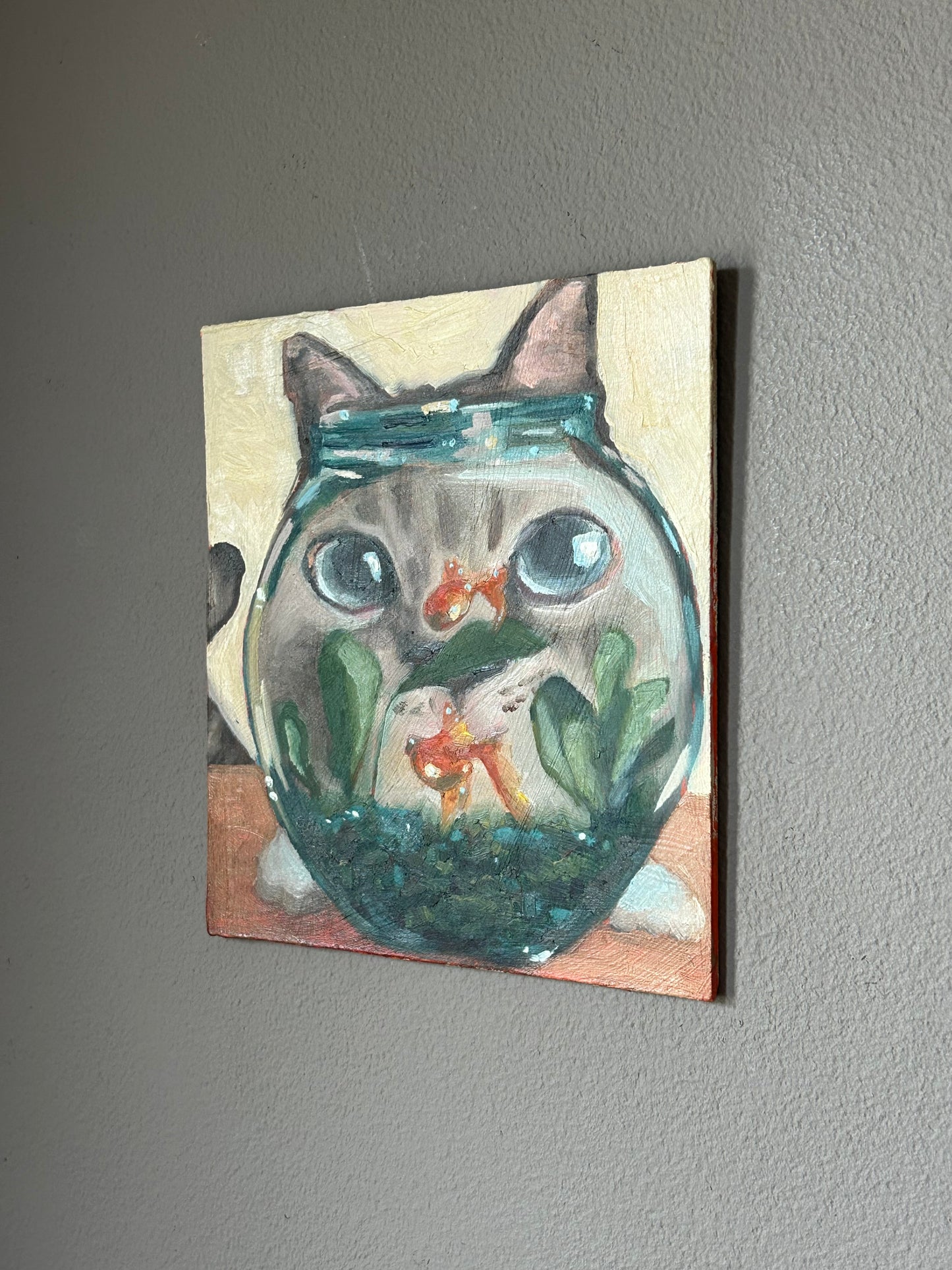 Curious cat and a fishbowl